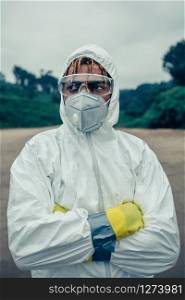 Young man with bacteriological protection suit and protective mask. Man with bacteriological protection suit