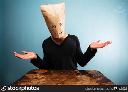 Young man with bag over head doesn&rsquo;t know