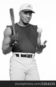 Young man with baseball bat and ball, smiling, portrait (B&W)