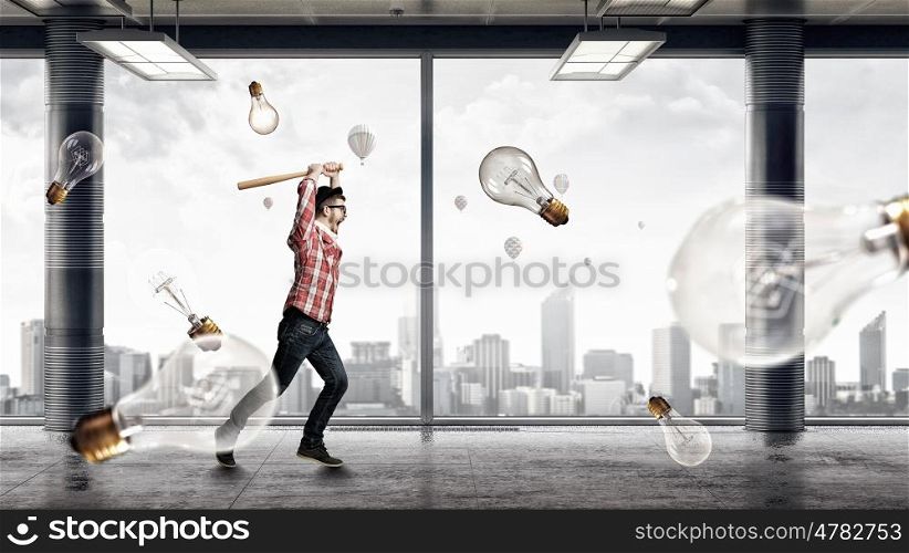 Young man with bat. Hipster guy with baseball bat and light bulbs around. Mixed media