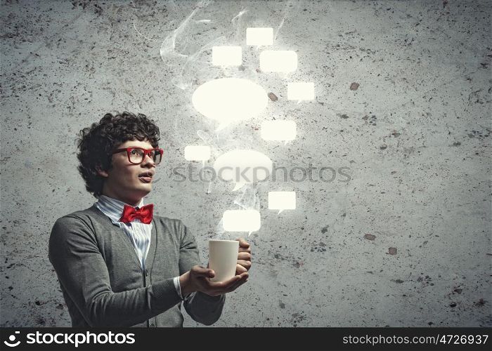 Young man with blank frames for text. Young man with blank frames against a grey wall