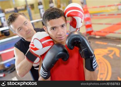 Young man with boxing instructor