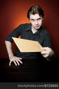 Young man with brown envelope.