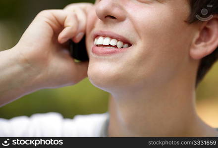 young man with cell-phone ,soft light and silver reflection for natural look, focus point on lips