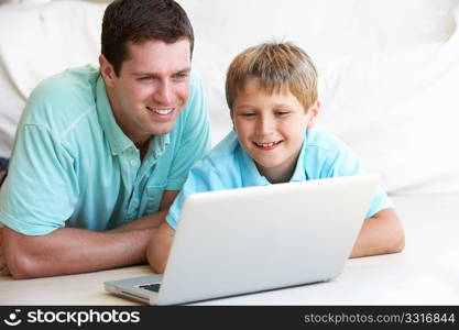 Young man with child on laptop computer