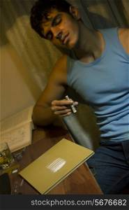 Young man with cocaine at home