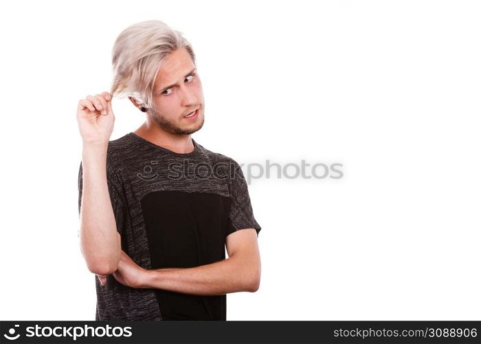 Young man with damaged dry hair after coloring, sad unhappy face expression, isolated on white copy space. Young man with damaged dry hair