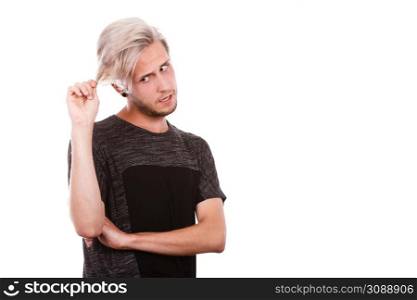 Young man with damaged dry hair after coloring, sad unhappy face expression, isolated on white copy space. Young man with damaged dry hair