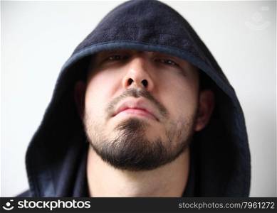 young man with dark hood hiding part of his face