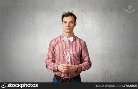 Young man with drawn light bulb in hands. Super idea