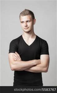 young man with folded arms isolated on light background