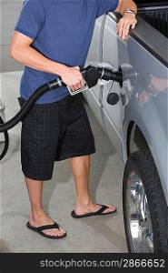 Young man with fuel pump