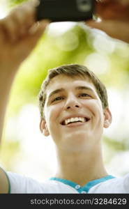 young man with gadget, natural light, selective focus on eye