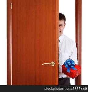 young man with gift opening the door