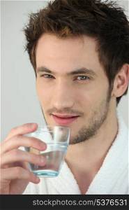 Young man with glass of water
