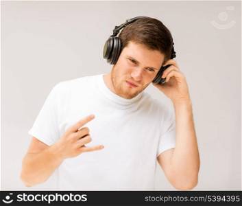 young man with headphones listening rock music