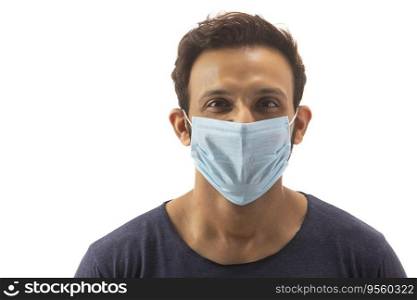 Young man with his face covered in a mask protecting himself from infections