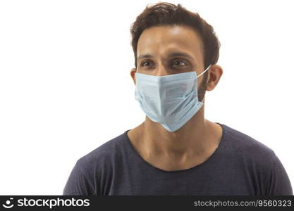 Young man with his face covered in a mask protecting himself from infections