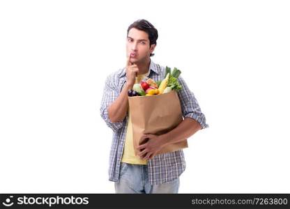 Young man with his grocery shopping on white. The young man with his grocery shopping on white
