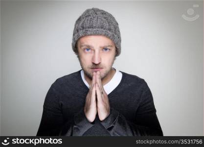 Young man with his hands folded, praying
