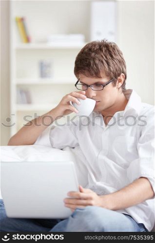 Young man with laptop at home