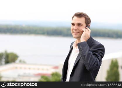 young man with mobile phone outdoors