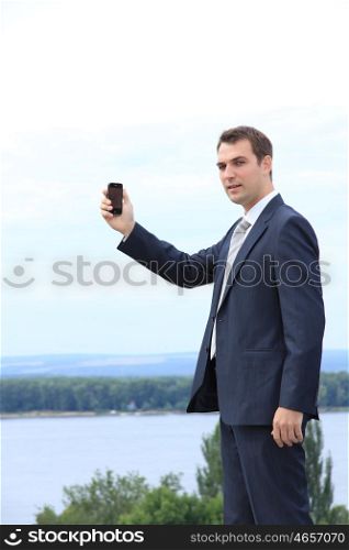 young man with mobile phone outdoors