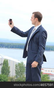 young man with mobile phone outdoors