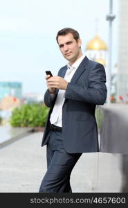 young man with mobile phone outdoors