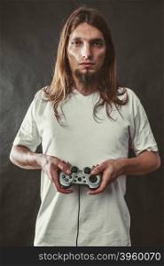 Young man with pad. Addiction and dependency concept. Young man with pad joystick playing games. Male addicted to console playstation videogames.