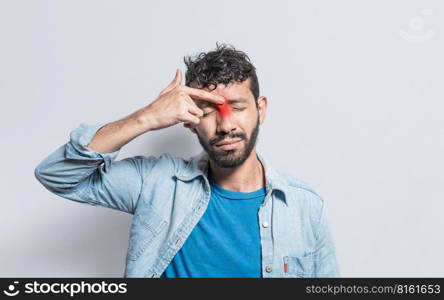 Young man with pain touching nose. A person with nasal bridge pain, Man with nasal bridge headache. Sinus pain concept