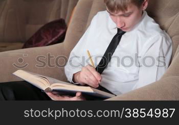 young man with pencil in hand prepares for study.