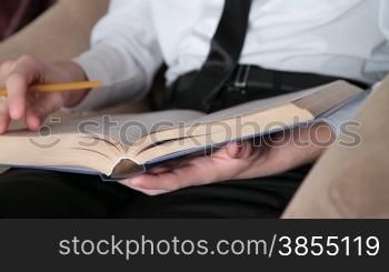 young man with pencil in hand prepares for study.