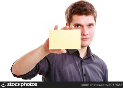Young man with piece of paper.. Advertisement concept. Young handsome man holding blank piece of paper. Smiling guy showing empty ad isolated on white.