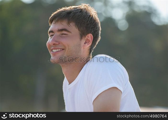 Young man with pure happiness on his face admiring sun