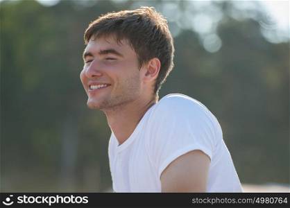 Young man with pure happiness on his face admiring sun