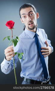 Young man with red rose