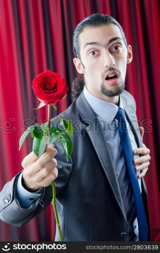 Young man with red rose