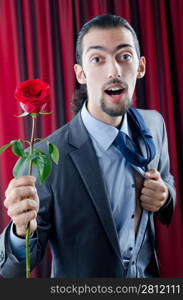 Young man with red rose