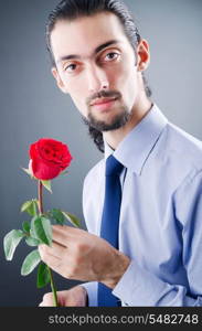 Young man with red rose