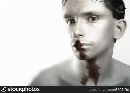 young man with silver makeup and bleeding hearts in mouth