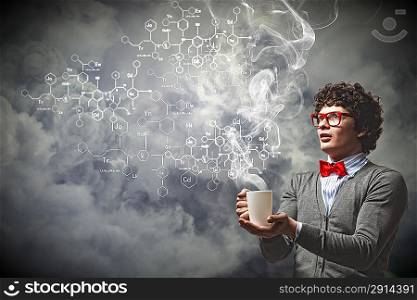 Young man with smoke coming out of cup