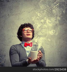 Young man with smoke coming out of cup