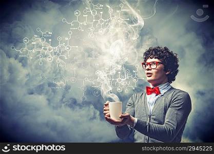 Young man with smoke coming out of cup