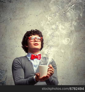 Young man with smoke coming out of cup