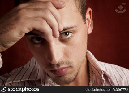 Young man with stubble in serious thought
