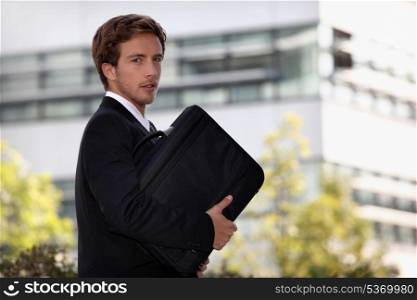 Young man with suitcase going to work