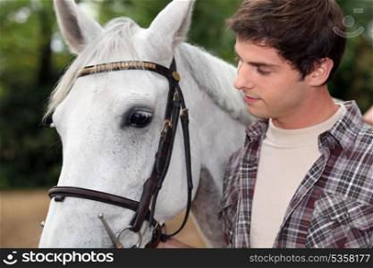 young man with white horse