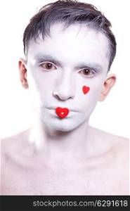 young man with white makeup and red hearts on face&#xA;