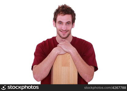 Young man with wooden floor boards